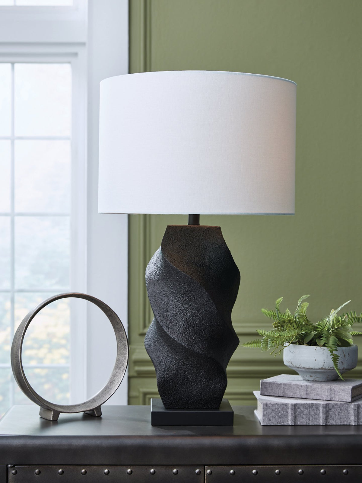 Ashley Furniture Amillion table lamp with a sleek design and fabric shade, shown in a close-up image.