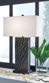 Ashley Furniture Bartlen table lamp with a sleek design and fabric shade, placed on a wooden side table.