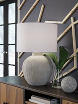 Ashley Furniture Calbert Table Lamp with fabric shade and wooden base, designed for stylish bedside or living room lighting.