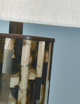 Ellford table lamp with a sleek base and fabric shade, designed by Ashley Furniture for modern home decor.