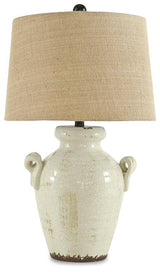 Emelda table lamp by Ashley Furniture with a sleek design and fabric shade, perfect for modern home decor.