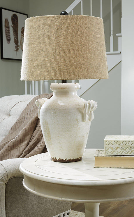 Emelda table lamp by Ashley Furniture with a modern design, featuring a sleek base and fabric lampshade for stylish home lighting.