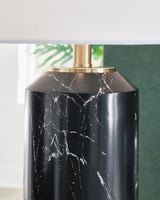 Hanzila table lamp by Ashley Furniture with a stylish ceramic base and fabric shade, ideal for bedside or living room decor.