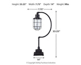 Ashley Furniture Jae Table Lamp with a sleek, modern design featuring a fabric shade and a sturdy base for desk or bedside use.