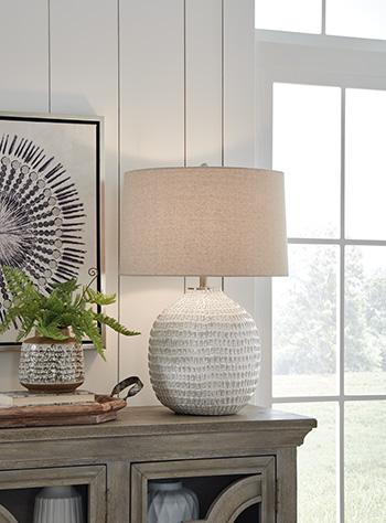 Ashley Furniture Jamon table lamp with a modern design, featuring a sleek base and a fabric lampshade.