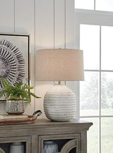 Ashley Furniture Jamon table lamp with a modern design, featuring a sleek base and a fabric lampshade.