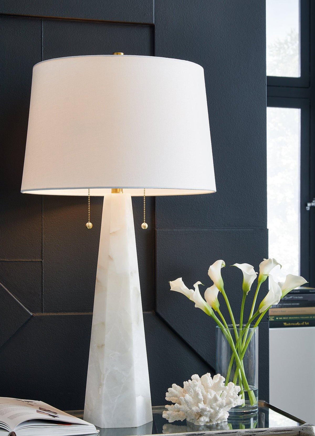 Laurellen table lamp by Ashley Furniture with a sleek base and fabric lampshade, ideal for bedside or living room decor.