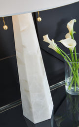 Ashley Furniture Laurellen table lamp with a sleek base and fabric shade, ideal for living room or bedroom decor.