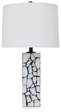 Ashley Furniture Macaria table lamp with a sleek design, featuring a beige fabric shade and a sturdy base for stylish lighting.