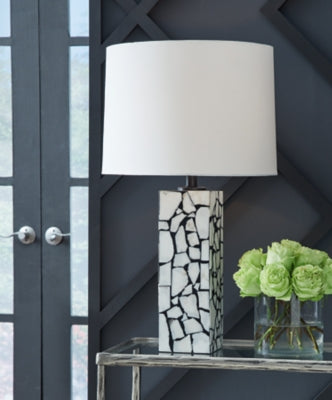 Ashley Furniture Macaria table lamp with a stylish base and fabric shade, ideal for enhancing living room or bedside decor.