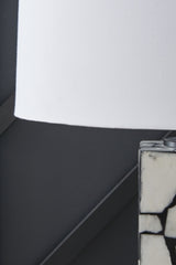 Detail of a Macaria table lamp shade by Ashley Furniture, showcasing its elegant fabric design and craftsmanship.