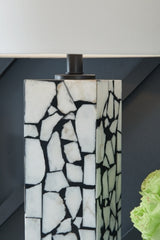 Ashley Furniture Macaria table lamp with a sleek design and fabric shade, perfect for adding ambient lighting to a room.