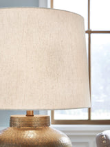 Madney table lamp by Ashley Furniture featuring a stylish base and fabric shade, ideal for contemporary home decor.