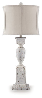 Ashley Furniture Madsbrook table lamp with a classic design, featuring a beige fabric shade and wooden base.