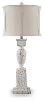 Ashley Furniture Madsbrook table lamp with a classic design, featuring a beige fabric shade and wooden base.