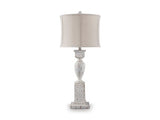 Ashley Furniture Madsbrook table lamp with a sleek base and fabric shade, perfect for living room or bedside lighting.