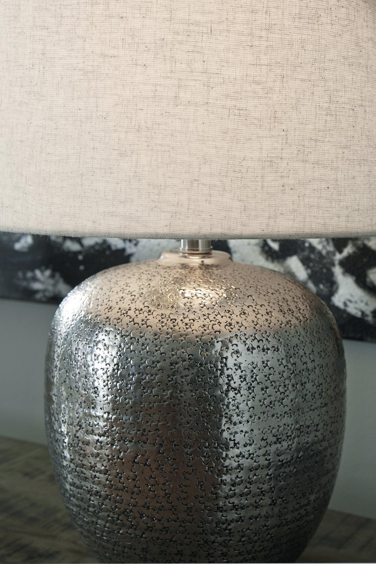 Magalie Ashley Furniture table lamp with a sleek base and fabric shade, ideal for living room or bedside decor.