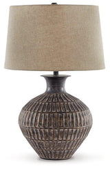 Ashley Furniture Magan table lamp with a sleek design and fabric shade, perfect for modern living room or bedside decor.