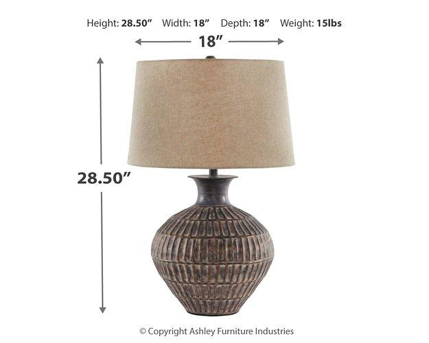 Ashley Furniture Magan Table Lamp with a sleek base and fabric lampshade, perfect for modern living room decor.