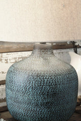 Malthace table lamp by Ashley Furniture featuring a stylish design with a fabric shade and a sleek base, ideal for living room decor.