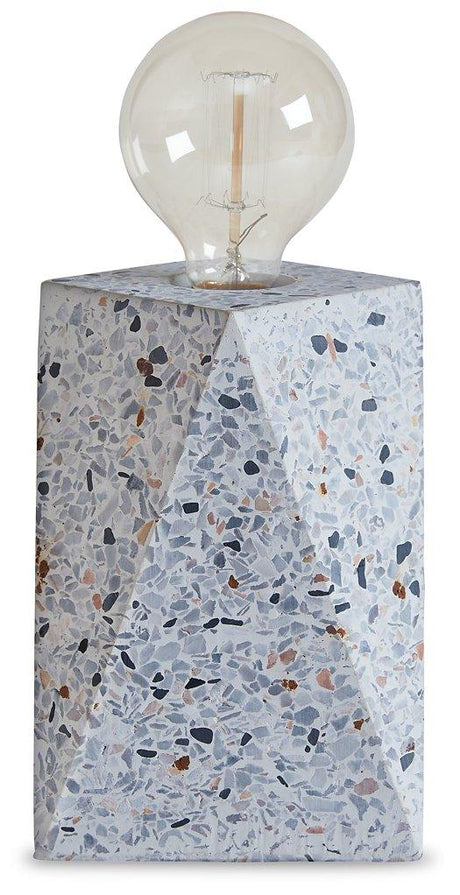 Maywick table lamp by Ashley Furniture featuring a sleek design with a fabric shade and modern base, ideal for bedside or living room.