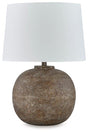 Neavesboro Ashley Furniture table lamp with a classic design featuring a fabric shade and wooden base on a wooden table.