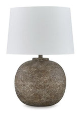 Ashley Furniture Neavesboro table lamp with a classic design, featuring a beige fabric lampshade and a wooden base.