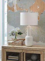 Ashley Furniture Perringhill table lamp with a classic design, featuring a beige fabric shade and a polished wooden base.