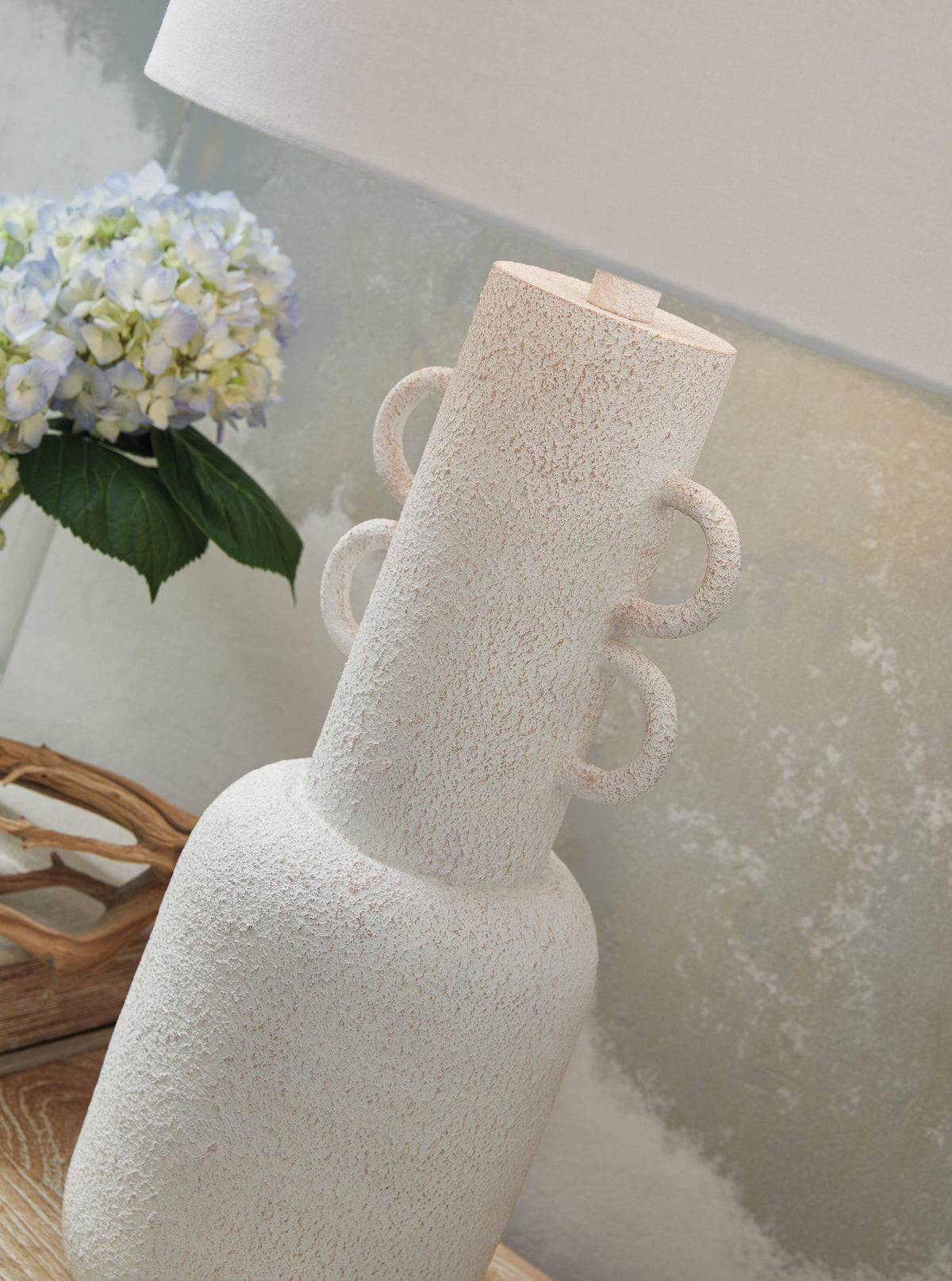 Perringhill table lamp by Ashley Furniture with a classic design and neutral fabric shade on a wooden base.
