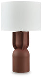 Ashley Furniture Rowandale table lamp with a beige fabric shade and dark metal base, placed on a wooden side table.