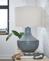 Schylarmont table lamp by Ashley Furniture with a classic base and fabric shade, perfect for bedside or living room lighting.