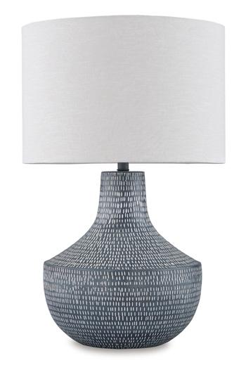 Ashley Furniture Schylarmont table lamp with a classic base and fabric shade, placed on a wooden side table.