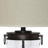 Ashley Furniture Tailynn Table Lamp with a sleek design, featuring a modern base and soft fabric shade on a wooden table.