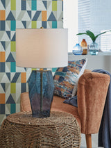 Tallow table lamp with a warm-toned ceramic base and fabric shade, designed for a stylish living room or bedside setting.