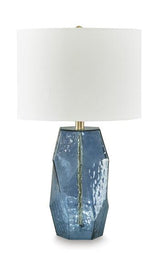 Tallow table lamp with a rustic base and fabric shade, designed for ambient lighting in a living room or bedroom.