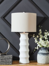 Ashley Furniture Veraleigh Table Lamp with a stylish fabric shade and decorative base, perfect for bedside or living room decor.