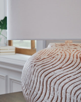 Ashley Furniture Vien table lamp with a sleek base and fabric shade, perfect for adding style to any room.
