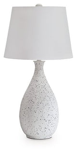 Ashley Furniture Wyattford table lamp with a sleek design, featuring a neutral-colored shade and a sturdy base.