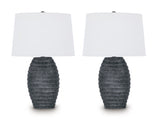 Pair of Caronick table lamps by Ashley Furniture with beige fabric shades and wooden bases, perfect for bedside or living room decor.