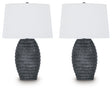 Pair of Ashley Furniture Caronick table lamps with beige fabric shades and dark bronze bases, designed for stylish home lighting.