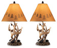 Pair of Derek table lamps by Ashley Furniture with beige fabric shades and brushed metal bases, ideal for bedside or living room.