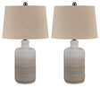 Pair of Marnina table lamps by Ashley Furniture, featuring elegant bases and fabric shades, perfect for bedside or living room decor.