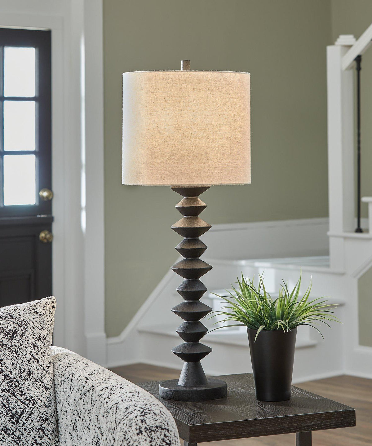 Luanndon table lamp set by Ashley Furniture featuring two elegant lamps with fabric shades and wooden bases on a wooden surface