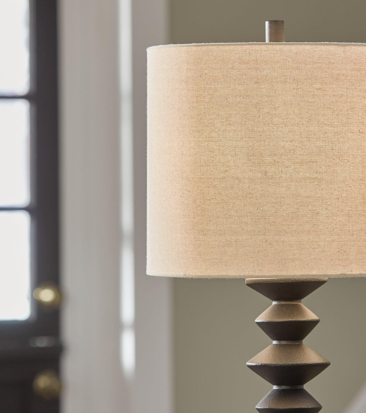 Set of two Ashley Furniture Luanndon table lamps with beige fabric shades and wooden bases, styled for a modern living space.