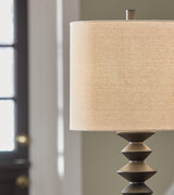 Set of two Ashley Furniture Luanndon table lamps with beige fabric shades and wooden bases, styled for a modern living space.