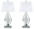 Ashley Furniture Prunella table lamp set with two stylish lamps featuring neutral fabric shades and wooden bases on a wood surface.