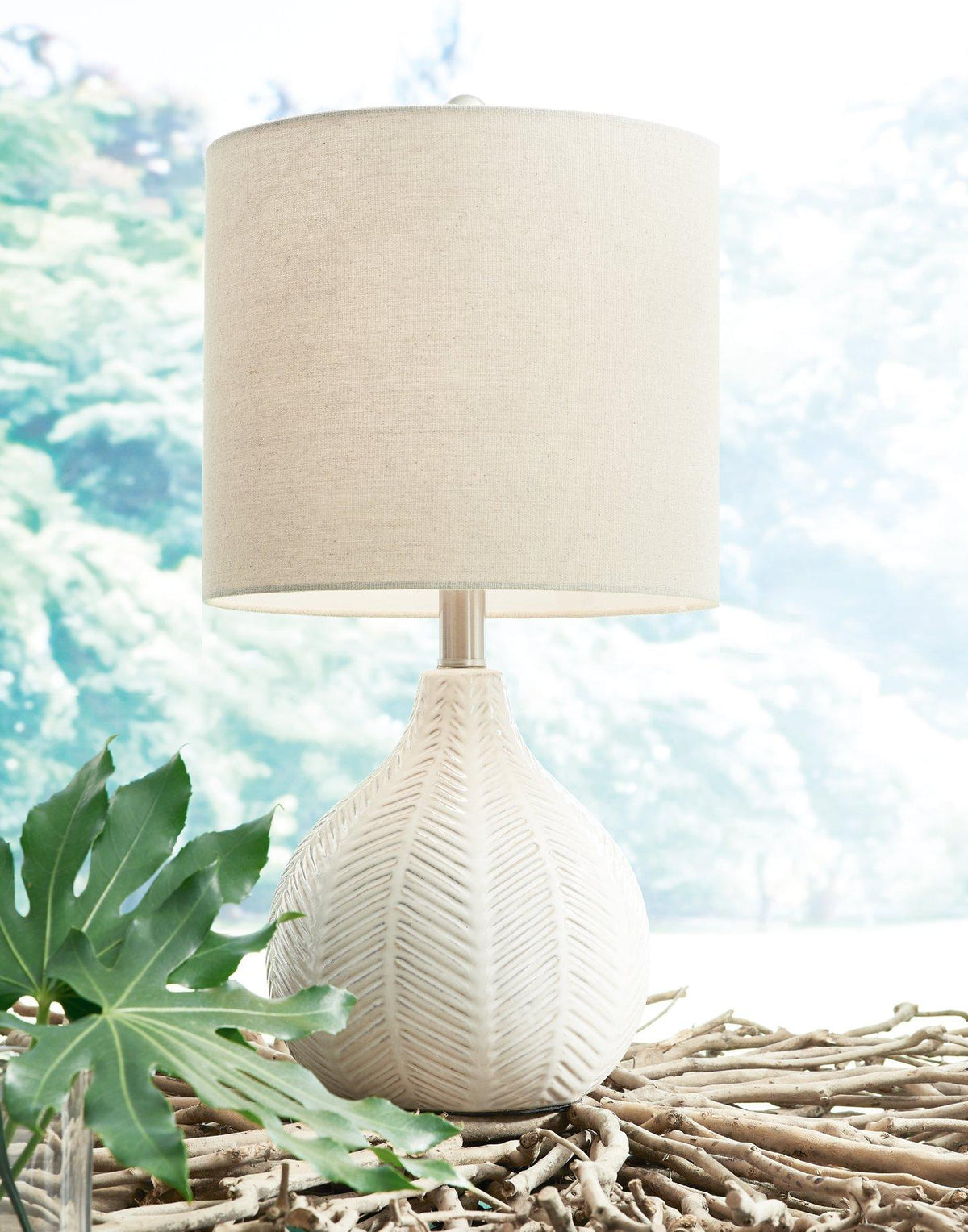 Ashley Furniture Rainermen table lamp set with two stylish lamps featuring neutral shades and modern bases.