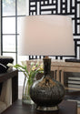Ashley Furniture Tenslow table lamp set featuring two modern, beige fabric lamps with black bases on a wooden surface.