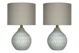 Pair of Ashley Furniture Wardmont table lamps with beige fabric shades and wooden bases, ideal for living room or bedside decor.