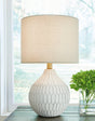 Pair of Ashley Furniture Wardmont table lamps with beige fabric shades and brushed nickel bases, ideal for bedroom or living room decor.